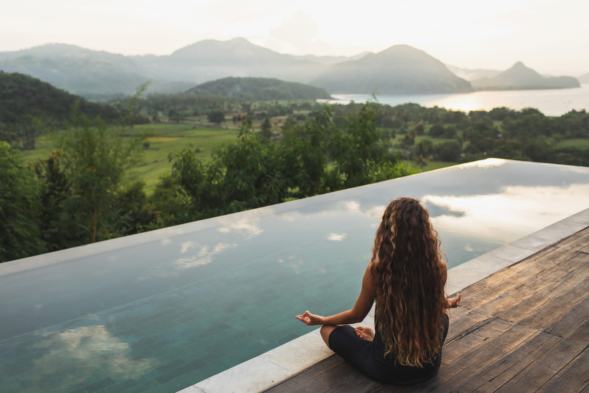 Woman practicing yoga at sunrise